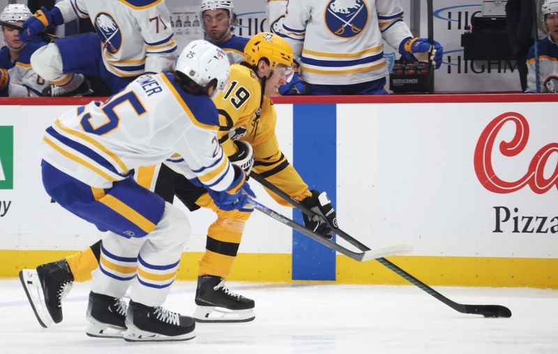 Mar 5, 2026; Pittsburgh, Pennsylvania, USA;  Pittsburgh Penguins center Connor Dewar (19) moves the puck against Buffalo Sabres defenseman Owen Power (25) during the first period at PPG Paints Arena. Mandatory Credit: Charles LeClaire-Imagn Images