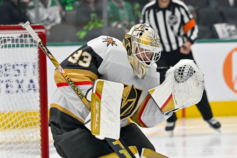 May 1, 2024; Dallas, Texas, USA; Vegas Golden Knights goaltender Adin Hill (33) is hit in the face mask by a Dallas Stars shot during the second period in game five of the first round of the 2024 Stanley Cup Playoffs at the American Airlines Center. Mandatory Credit: Jerome Miron-USA TODAY Sports