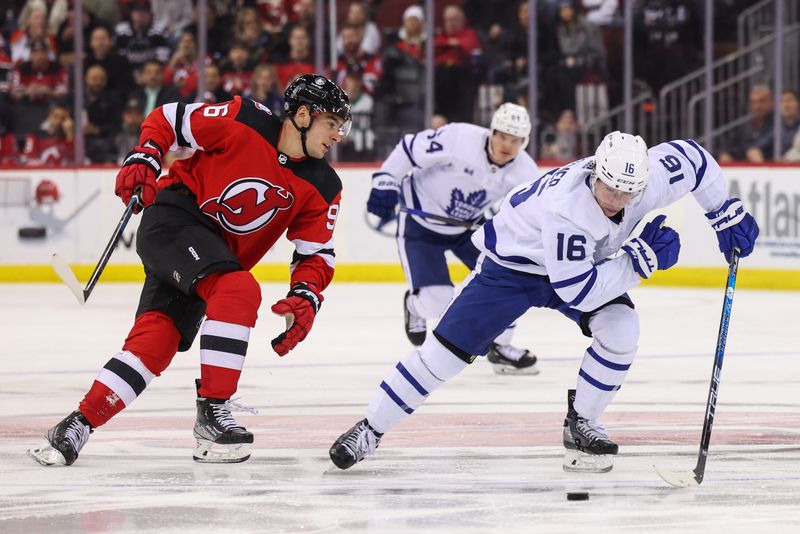 Mar 7, 2023; Newark, New Jersey, USA; Toronto Maple Leafs right wing Mitchell Marner (16) skates with the puck against the New Jersey Devils during the third period at Prudential Center. Mandatory Credit: Ed Mulholland-USA TODAY Sports