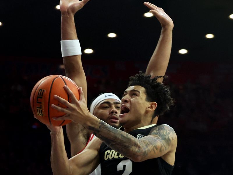 Jan 4, 2024; Tucson, Arizona, USA; Colorado Buffaloes guard KJ Simpson (2) drives to the net against Arizona Wildcats guard Kylan Boswell (4) during the first half at McKale Center. Mandatory Credit: Zachary BonDurant-USA TODAY Sports