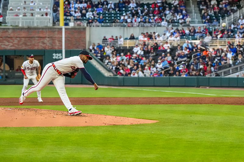 Apr 21, 2024; Cumberland, Georgia, USA; Atlanta Braves starting pitcher Darius Vines (61) pitches against the Texas Rangers during the third inning at Truist Park. Mandatory Credit: Dale Zanine-USA TODAY Sports