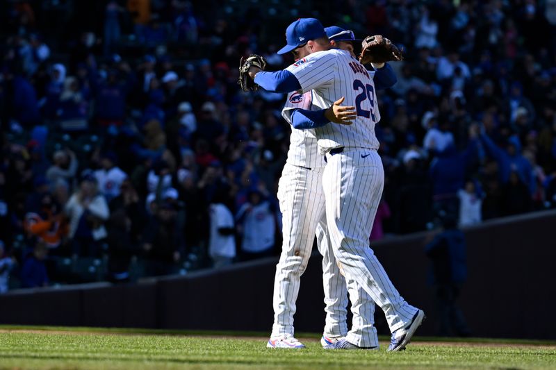 Apr 5, 2024; Chicago, Illinois, USA;  Chicago Cubs first base Michael Busch (29) and third base Nick Madrigal celebrate after defeating the Los Angeles Dodgers at Wrigley Field. Mandatory Credit: Matt Marton-USA TODAY Sports