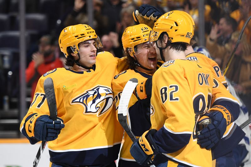 Dec 3, 2023; Nashville, Tennessee, USA; Nashville Predators players celebrate after a goal by center Juuso Parssinen (75) during the first period at Bridgestone Arena Mandatory Credit: Christopher Hanewinckel-USA TODAY Sports