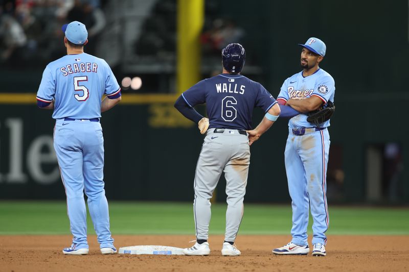 Apr 6, 2025; Arlington, Texas, USA; Texas Rangers shortstop Corey Seager (5) and Texas Rangers second base Marcus Semien (2) talks to Tampa Bay Rays shortstop Taylor Walls (6) during a replay time out in the game at Globe Life Field. Mandatory Credit: Tim Heitman-Imagn Images