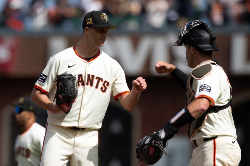 May 18, 2024; San Francisco, California, USA; San Francisco Giants pitcher Taylor Rogers (33) and catcher Curt Casali (18) celebrate their 14-4 victory over the Colorado Rockies at Oracle Park. Mandatory Credit: D. Ross Cameron-USA TODAY Sports