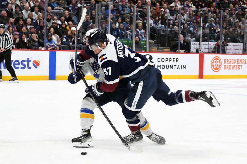 Jan 31, 2025; Denver, Colorado, USA; Colorado Avalanche center Casey Mittelstadt (37) is hit by St. Louis Blues left wing Nathan Walker (26) during the second period at Ball Arena. Mandatory Credit: Christopher Hanewinckel-Imagn Images