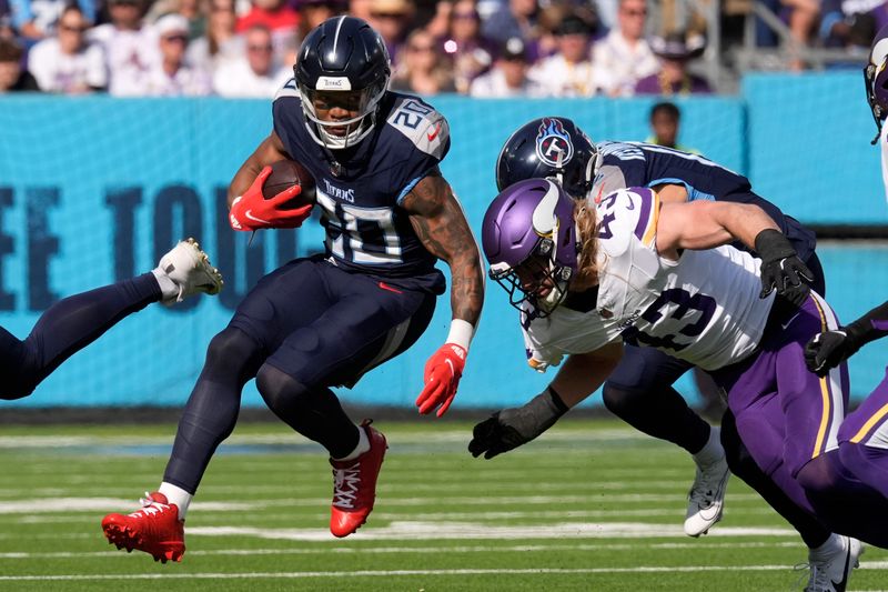 Tennessee Titans running back Tony Pollard (20) run from Minnesota Vikings linebacker Andrew Van Ginkel (43) during the first half of an NFL football game, Sunday, Nov. 17, 2024, in Nashville, Tenn. (AP Photo/George Walker IV)