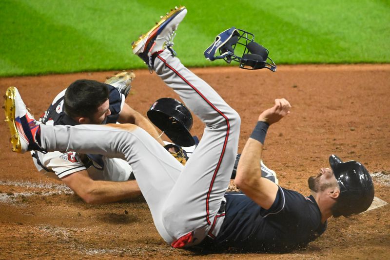 Jul 4, 2023; Cleveland, Ohio, USA; Cleveland Guardians catcher David Fry (12) tags out Atlanta Braves center fielder Sam Hilliard (14) in the tenth inning at Progressive Field. Mandatory Credit: David Richard-USA TODAY Sports