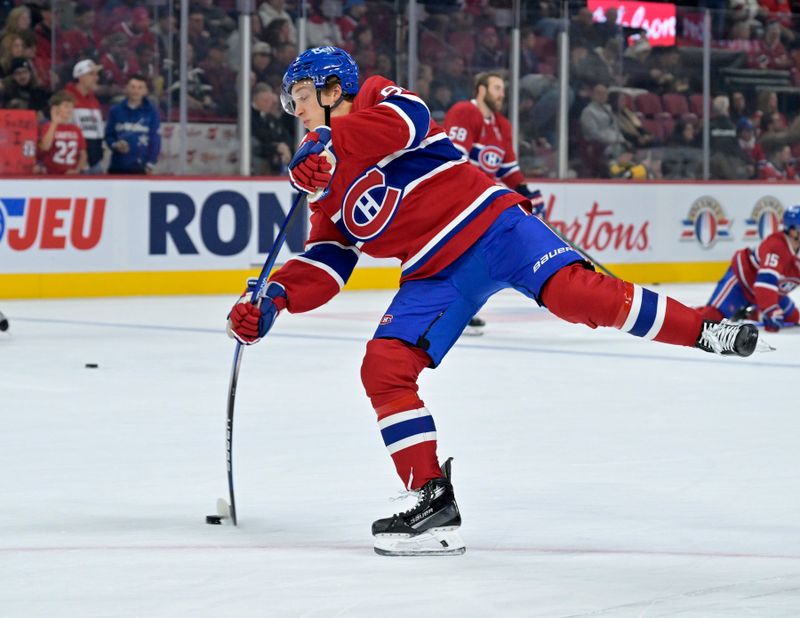 Oct 14, 2024; Montreal, Quebec, CAN; Montreal Canadiens forward Oliver Kapanen (91) takes a shot during the warmup period before the game against the Pittsburgh Penguins at the Bell Centre. Mandatory Credit: Eric Bolte-Imagn Images