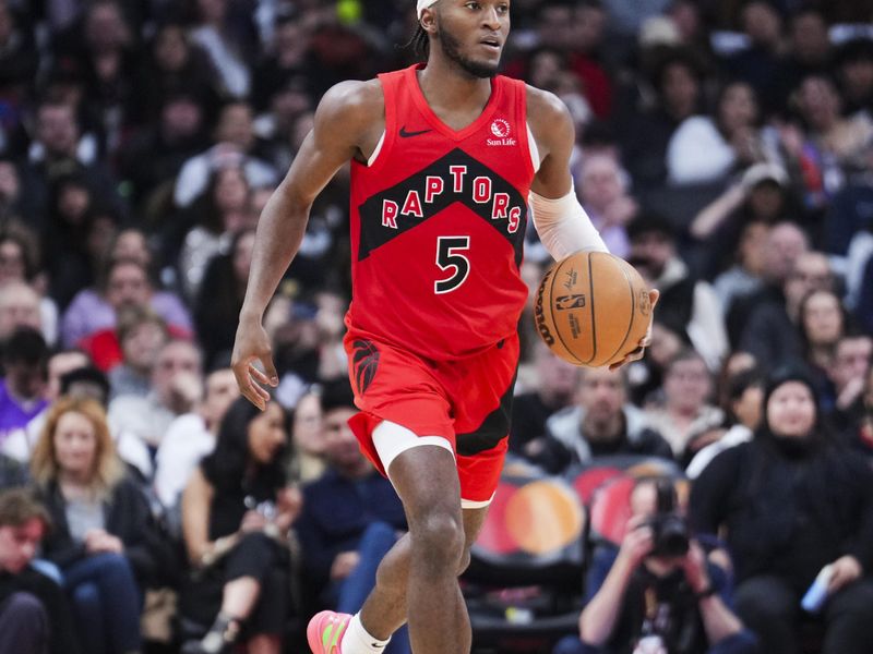 TORONTO, ON - JANUARY 1: Immanuel Quickley #5 of the Toronto Raptors dribbles against the Brooklyn Nets during the second half of their basketball game at the Scotiabank Arena on January 1, 2025 in Toronto, Ontario, Canada. NOTE TO USER: User expressly acknowledges and agrees that, by downloading and/or using this Photograph, user is consenting to the terms and conditions of the Getty Images License Agreement. (Photo by Mark Blinch/Getty Images)