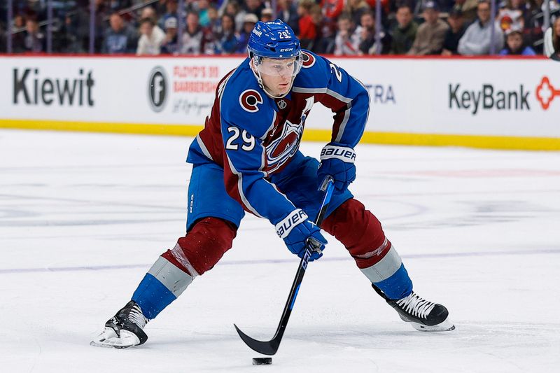 Jan 19, 2026; Denver, Colorado, USA; Colorado Avalanche center Nathan MacKinnon (29) controls the puck in the second period against the Washington Capitals at Ball Arena. Mandatory Credit: Isaiah J. Downing-Imagn Images