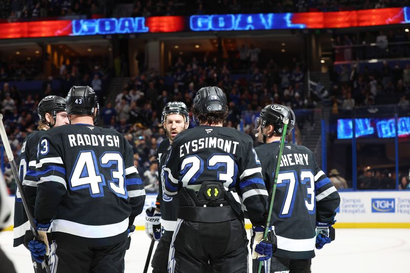 Nov 30, 2024; Tampa, Florida, USA; Tampa Bay Lightning center Michael Eyssimont (23) is congratulated  by defenseman Darren Raddysh (43), left wing Conor Sheary (73) and teammates after he scored a goal against the Toronto Maple Leafs during the third period at Amalie Arena. Mandatory Credit: Kim Klement Neitzel-Imagn Images