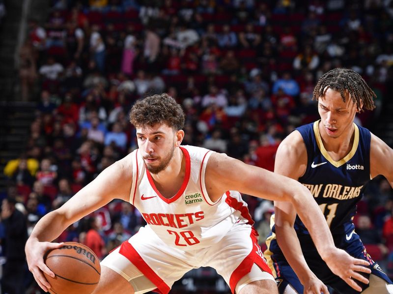 HOUSTON, TX - JANUARY 31:  Alperen Sengun #28 of the Houston Rockets handles the ball during the game against the New Orleans Pelicans on January 31, 2024 at the Toyota Center in Houston, Texas. NOTE TO USER: User expressly acknowledges and agrees that, by downloading and or using this photograph, User is consenting to the terms and conditions of the Getty Images License Agreement. Mandatory Copyright Notice: Copyright 2024 NBAE (Photo by Logan Riely/NBAE via Getty Images)