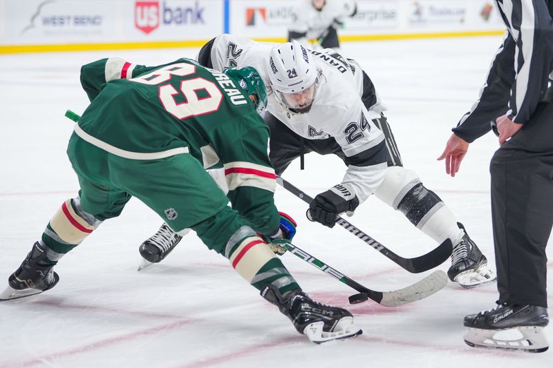 Nov 5, 2024; Saint Paul, Minnesota, USA; Minnesota Wild center Frederick Gaudreau (89) and Los Angeles Kings center Phillip Danault (24) take the faceoff in the first period at Xcel Energy Center. Mandatory Credit: Brad Rempel-Imagn Images