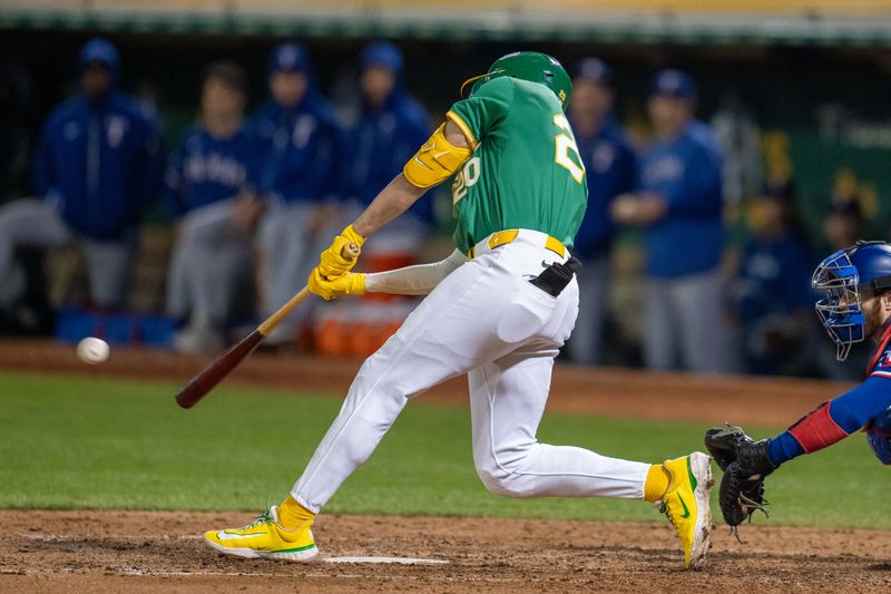 Sep 24, 2024; Oakland, California, USA; Oakland Athletics second baseman Zack Gelof (20) hits a single during the ninth inning against the Texas Rangers at Oakland-Alameda County Coliseum. Mandatory Credit: Neville E. Guard-Imagn Images