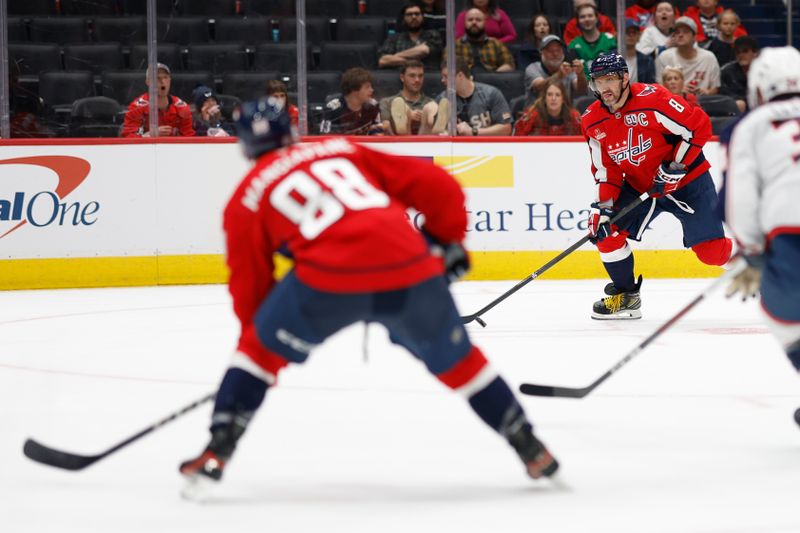 Sep 27, 2024; Washington, District of Columbia, USA; Washington Capitals left wing Alex Ovechkin (8) prepares to pass the puck to Capitals left wing Andrew Mangiapane (88) as Columbus Blue Jackets defenseman Cole Clayton (34) defends in the third period at Capital One Arena. Mandatory Credit: Geoff Burke-Imagn Images