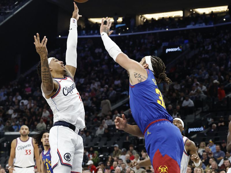 INGLEWOOD, CALIFORNIA - DECEMBER 01: Jordan Miller #11 of the LA Clippers shoots against Aaron Gordon #32 of the Denver Nuggets in the first half at Intuit Dome on December 01, 2024 in Inglewood, California.  NOTE TO USER: User expressly acknowledges and agrees that, by downloading and or using this photograph, User is consenting to the terms and conditions of the Getty Images License Agreement. (Photo by Ronald Martinez/Getty Images)