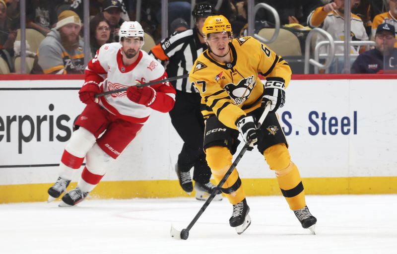 Jan 1, 2026; Pittsburgh, Pennsylvania, USA;  Pittsburgh Penguins right wing Rickard Rakell (67) moves the puck against the Detroit Red Wings in overtime at PPG Paints Arena. Mandatory Credit: Charles LeClaire-Imagn Images