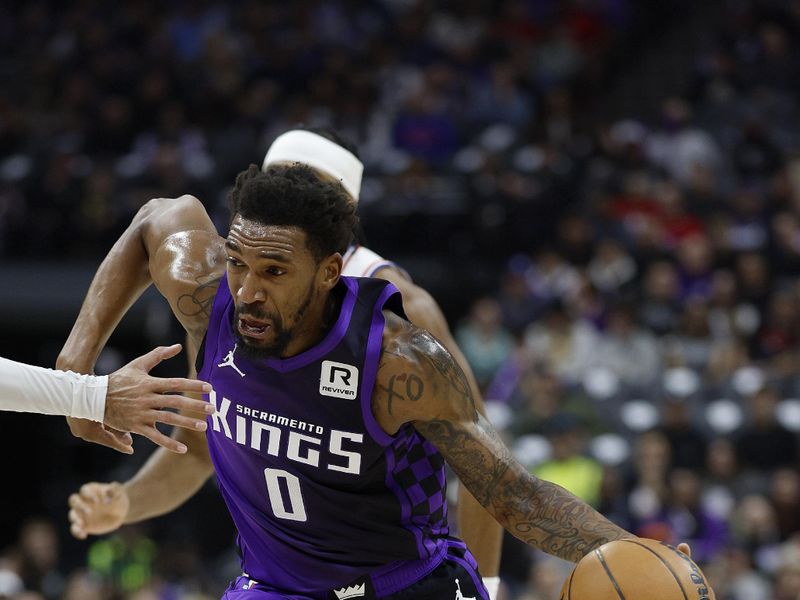 SACRAMENTO, CALIFORNIA - JANUARY 01: Malik Monk #0 of the Sacramento Kings dribbling the ball looks to drive to the basket against the Philadelphia 76ers during the first half of an NBA basketball game at Golden 1 Center on January 01, 2025 in Sacramento, California. NOTE TO USER: User expressly acknowledges and agrees that, by downloading and or using this photograph, User is consenting to the terms and conditions of the Getty Images License Agreement. (Photo by Thearon W. Henderson/Getty Images)