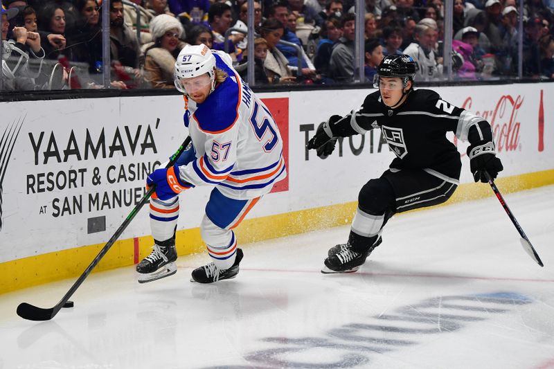 Dec 30, 2023; Los Angeles, California, USA; Edmonton Oilers left wing James Hamblin (57) moves the puck against Los Angeles Kings defenseman Jordan Spence (21) during the third period at Crypto.com Arena. Mandatory Credit: Gary A. Vasquez-USA TODAY Sports