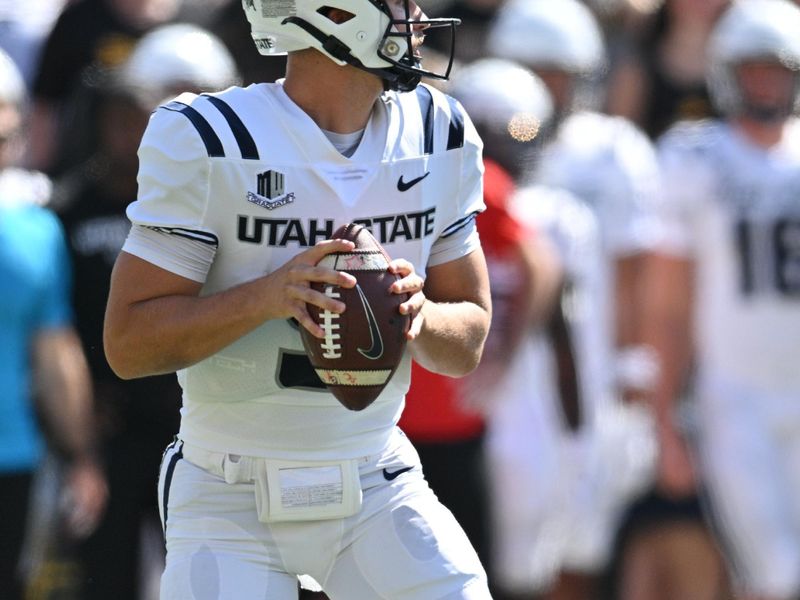 Sep 2, 2023; Iowa City, Iowa, USA; Utah State Aggies quarterback Cooper Legas (5) looks to throw a pass against the Iowa Hawkeyes during the first quarter at Kinnick Stadium. Mandatory Credit: Jeffrey Becker-USA TODAY Sports