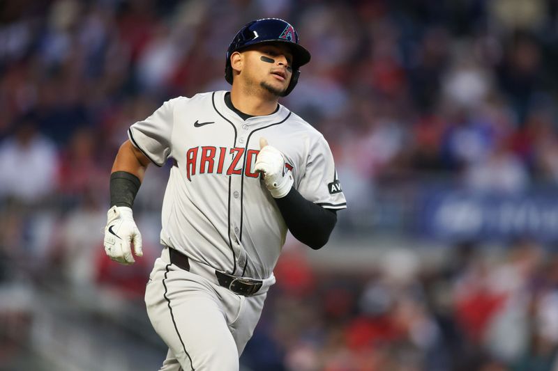 Apr 6, 2024; Atlanta, Georgia, USA; Arizona Diamondbacks catcher Gabriel Moreno (14) hits a single against the Atlanta Braves in the third inning at Truist Park. Mandatory Credit: Brett Davis-USA TODAY Sports