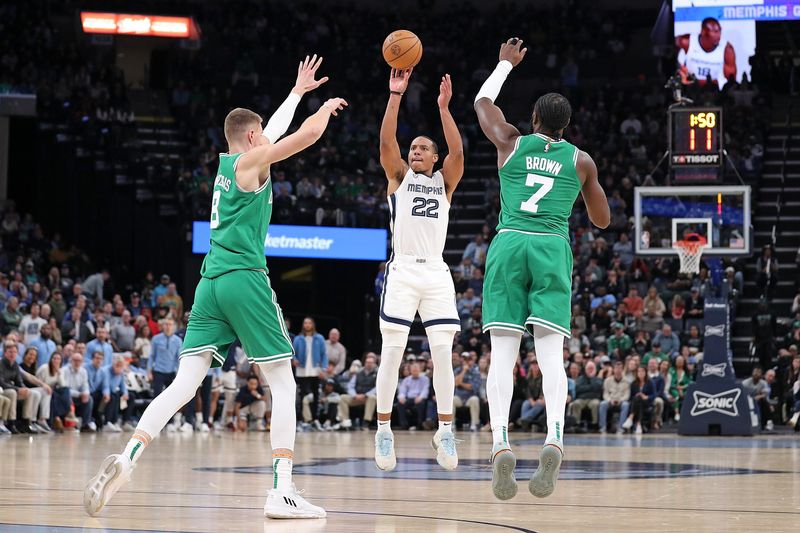 MEMPHIS, TENNESSEE - NOVEMBER 19: Desmond Bane #22 of the Memphis Grizzlies takes a shot during the second half against Kristaps Porzingis #8 of the Boston Celtics at FedExForum on November 19, 2023 in Memphis, Tennessee. NOTE TO USER: User expressly acknowledges and agrees that, by downloading and or using this photograph, User is consenting to the terms and conditions of the Getty Images License Agreement.  (Photo by Justin Ford/Getty Images)