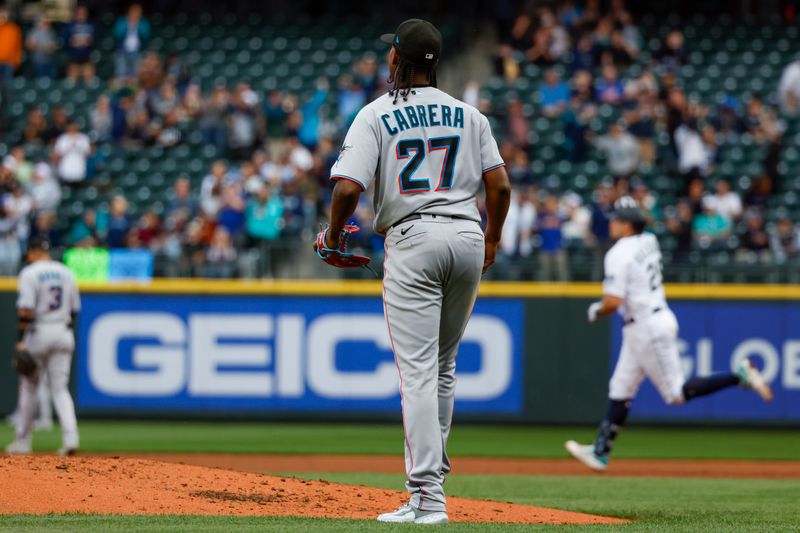 Jun 13, 2023; Seattle, Washington, USA; Miami Marlins starting pitcher Edward Cabrera (27) watches a replay of a three-run home run by Seattle Mariners catcher Cal Raleigh (29, background) during the second inning at T-Mobile Park. Mandatory Credit: Joe Nicholson-USA TODAY Sports