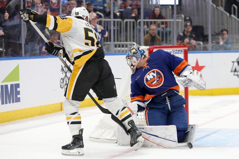 Nov 5, 2024; Elmont, New York, USA; New York Islanders goaltender Ilya Sorokin (30) makes the winning save against Pittsburgh Penguins defenseman Kris Letang (58) during the shootout at UBS Arena. Mandatory Credit: Brad Penner-Imagn Images