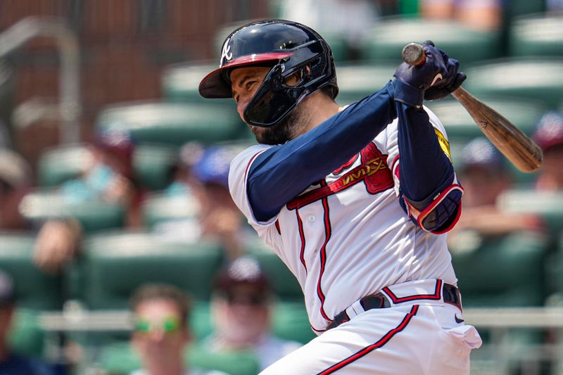 Aug 2, 2023; Cumberland, Georgia, USA; Atlanta Braves catcher Travis d'Arnaud (16) hits a single to drive in two runs against the Los Angeles Angels during the sixth inning at Truist Park. Mandatory Credit: Dale Zanine-USA TODAY Sports