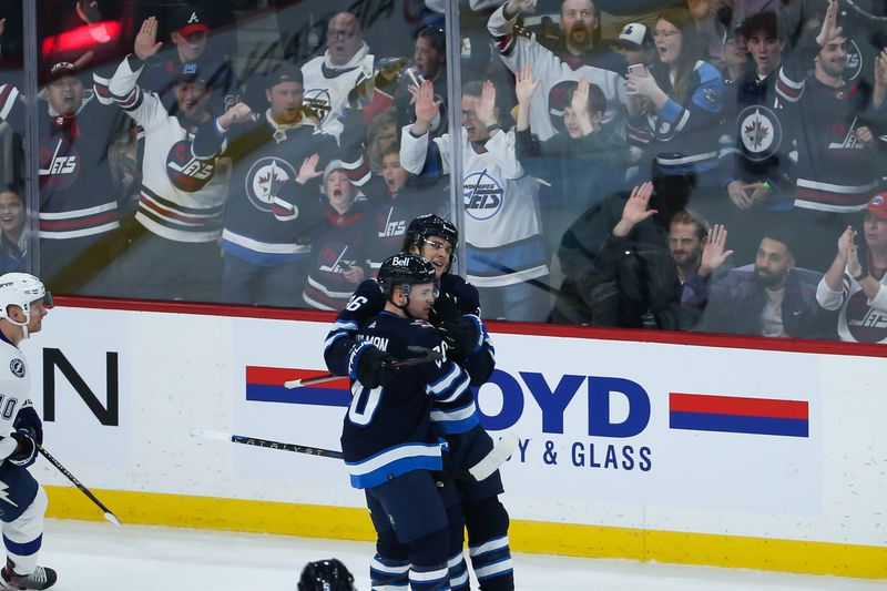 Jan 6, 2023; Winnipeg, Manitoba, CAN;  Winnipeg Jets forward Morgan Barron (36) is congratulated by Winnipeg Jets forward Karson Kuhlman (20) on his goal against the Tampa Bay Lightning during the third period at Canada Life Centre. Mandatory Credit: Terrence Lee-USA TODAY Sports