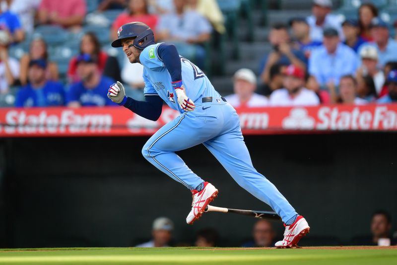 Aug 12, 2024; Anaheim, California, USA; Toronto Blue Jays third baseman Ernie Clement (28) runs after hitting a single against the Los Angeles Angels during the first inning at Angel Stadium. Mandatory Credit: Gary A. Vasquez-USA TODAY Sports