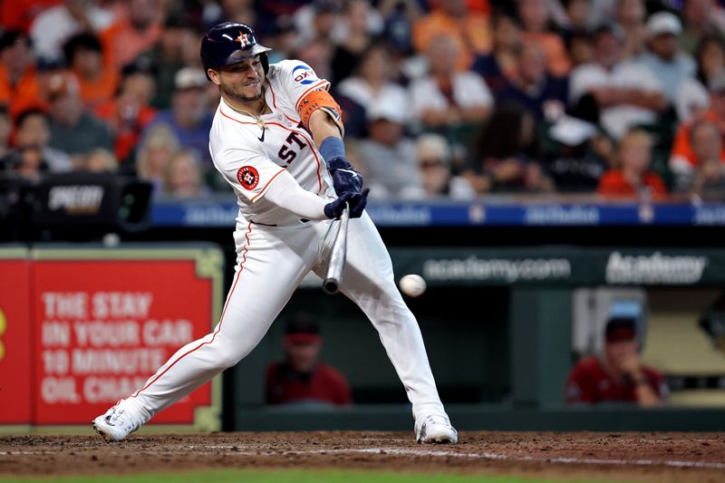 Sep 7, 2024; Houston, Texas, USA; Houston Astros first baseman Yainer Diaz (21) hits an RBI single against the Arizona Diamondbacks during the sixth inning at Minute Maid Park. Mandatory Credit: Erik Williams-Imagn Images
