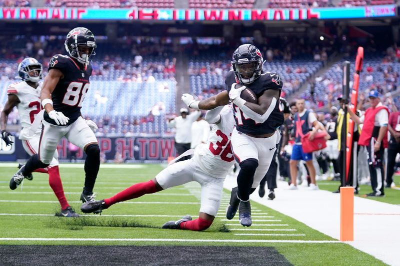 Houston Texans running back British Brooks (44) scores on a running play after getting past New York Giants cornerback Mario Goodrich, rear, in the second half of a preseason NFL football game, Saturday, Aug. 17, 2024, in Houston. (AP Photo/Eric Christian Smith)