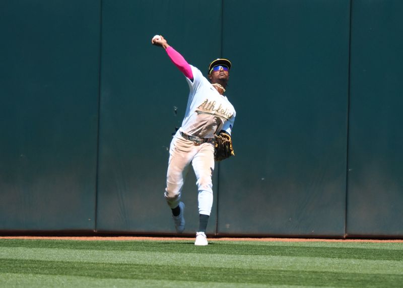 May 17, 2023; Oakland, California, USA; Oakland Athletics center fielder Esteury Ruiz (1) throws the ball against the Arizona Diamondbacks during the ninth inning at Oakland-Alameda County Coliseum. Mandatory Credit: Kelley L Cox-USA TODAY Sports