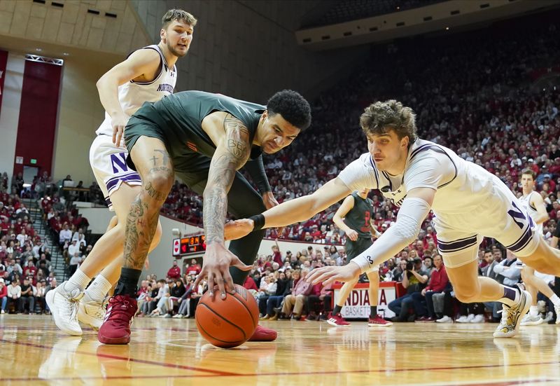 Feb 18, 2024; Bloomington, Indiana, USA;  Indiana Hoosiers center Kel'el Ware (1) and Northwestern Wildcats forward Nick Martinelli (2) battle for a loose ball during the second half at Simon Skjodt Assembly Hall. Mandatory Credit: Robert Goddin-USA TODAY Sports