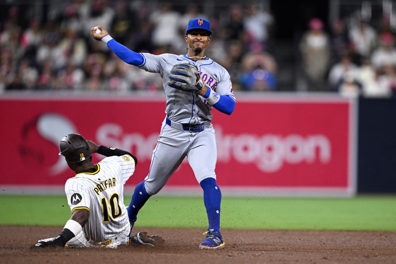 Aug 22, 2024; San Diego, California, USA; New York Mets shortstop Francisco Lindor (12) throws to first base after forcing out San Diego Padres left fielder Jurickson Profar (10) at second base to complete a double play during the fifth inning at Petco Park. Mandatory Credit: Orlando Ramirez-USA TODAY Sports