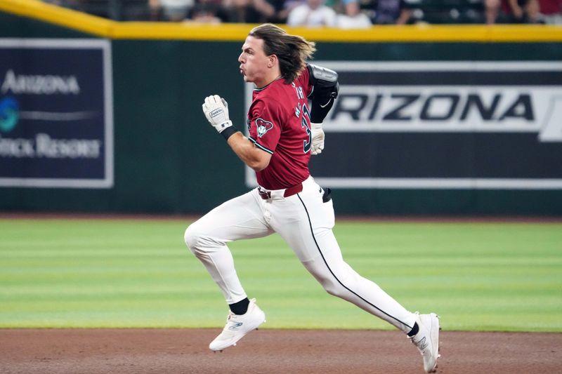 Jul 28, 2024; Phoenix, Arizona, USA; Arizona Diamondbacks outfielder Jake McCarthy (31) runs to third base en route a triple against the Pittsburgh Pirates during the fourth inning at Chase Field. Mandatory Credit: Joe Camporeale-USA TODAY Sports