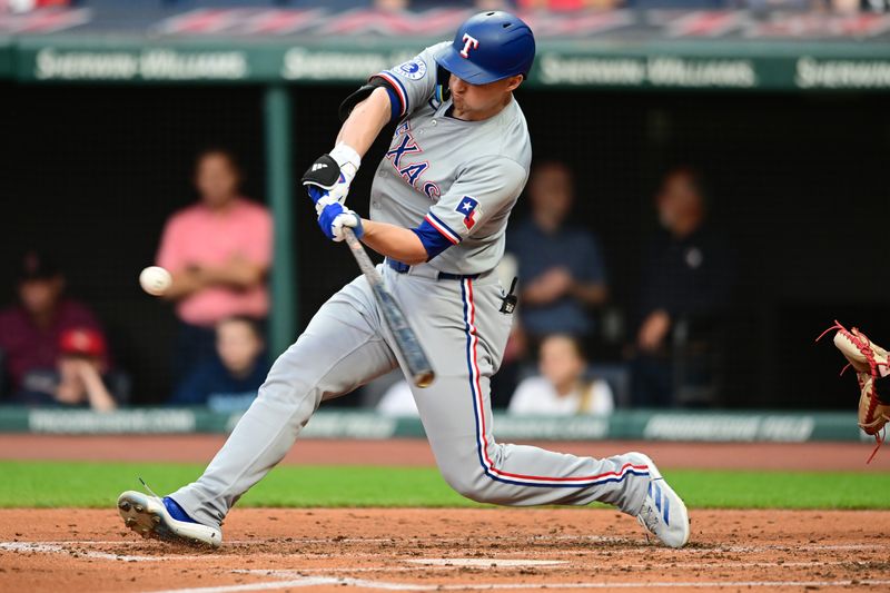 Aug 23, 2024; Cleveland, Ohio, USA; Texas Rangers shortstop Corey Seager (5) hits an RBI double during the second inning against the Cleveland Guardians at Progressive Field. Mandatory Credit: Ken Blaze-USA TODAY Sports