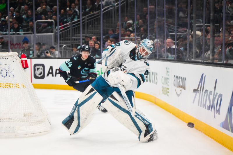 Jan 30, 2025; Seattle, Washington, USA; San Jose Sharks goaltender Alexandar Georgiev (40) clears the puck against the Seattle Kraken during the third period at Climate Pledge Arena. Mandatory Credit: Steven Bisig-Imagn Images