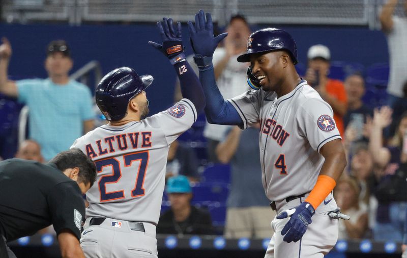 Aug 5, 2025; Miami, Florida, USA;  Houston Astros outfielder Jose Altuve (27) is greeted at the plate by outfielder Jesus Sanchez (4) after his two run home run against the Miami Marlins during the first inning at loanDepot Park. Mandatory Credit: Rhona Wise-Imagn Images