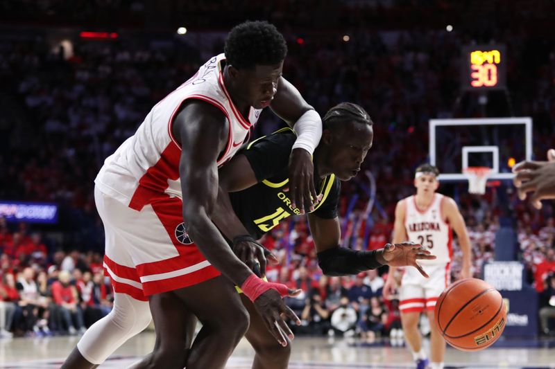 Feb 2, 2023; Tucson, Arizona, USA; Arizona Wildcats center Oumar Ballo (11) dives for a loose ball against Oregon Ducks forward Lok Wur (15) in the second half at McKale Center. Mandatory Credit: Zachary BonDurant-USA TODAY Sports