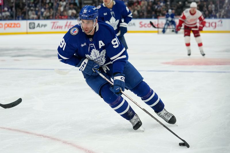 Nov 8, 2024; Toronto, Ontario, CAN; Toronto Maple Leafs forward John Tavares (91) carries the puck against the Detroit Red Wings during the third period at Scotiabank Arena. Mandatory Credit: John E. Sokolowski-Imagn Images