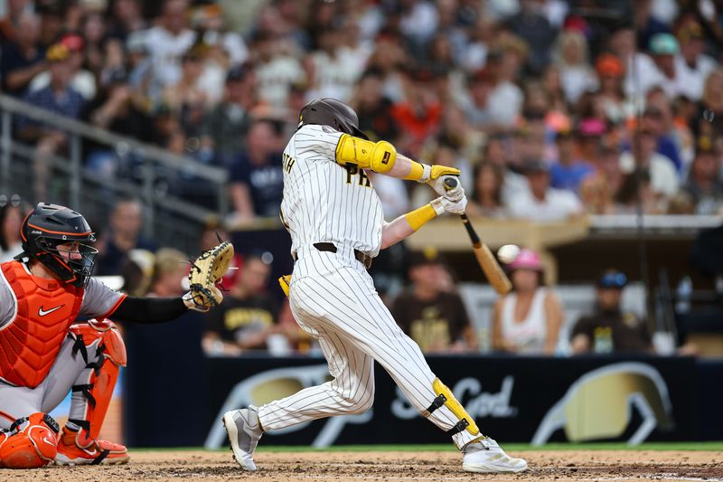 Sep 7, 2024; San Diego, California, USA; San Diego Padres first baseman Jake Cronenworth (9) singles against the San Francisco Giants in the fifth inning at Petco Park. Mandatory Credit: Chadd Cady-Imagn Images