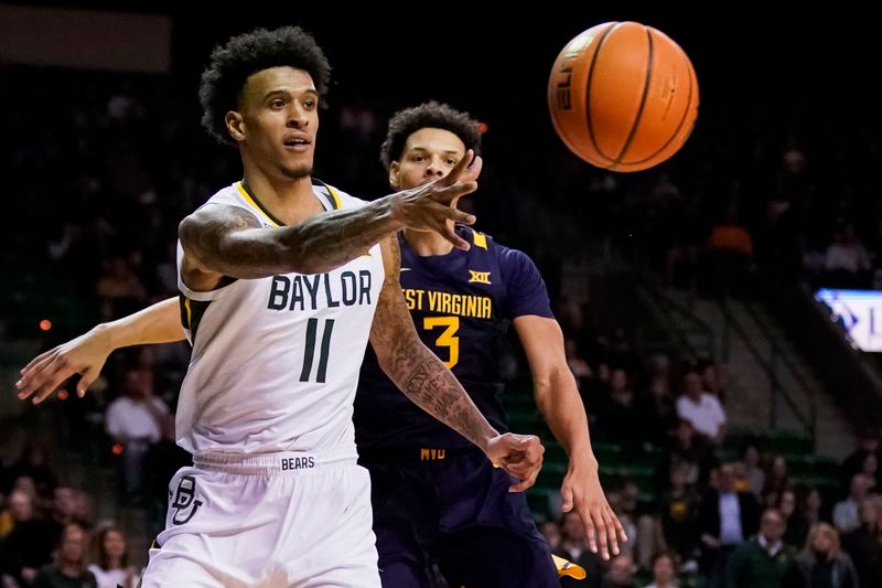 Feb 13, 2023; Waco, Texas, USA; Baylor Bears forward Jalen Bridges (11) passes the ball as West Virginia Mountaineers forward Tre Mitchell (3) defends during the second half at Ferrell Center. Mandatory Credit: Raymond Carlin III-USA TODAY Sports