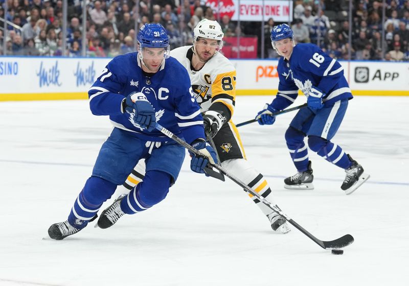 Apr 8, 2024; Toronto, Ontario, CAN; Toronto Maple Leafs center John Tavares (91) battles for the puck with Pittsburgh Penguins center Sidney Crosby (87) during the third period at Scotiabank Arena. Mandatory Credit: Nick Turchiaro-USA TODAY Sports