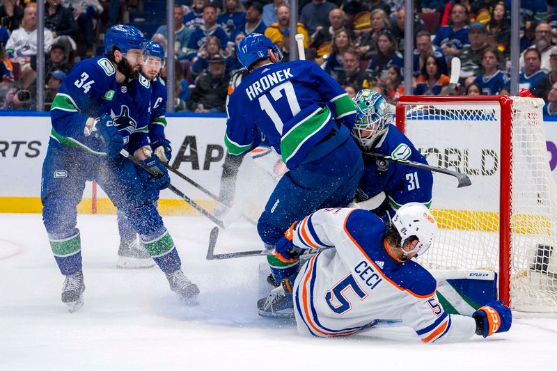 May 20, 2024; Vancouver, British Columbia, CAN; Vancouver Canucks forward Phillip Di Giuseppe (34) watches as goalie Arturs Silvos (31) makes a save while defenseman Filip Hronek (17) and Edmonton Oilers defenseman Cody Ceci (5) collide with Silvos during the second period in game seven of the second round of the 2024 Stanley Cup Playoffs at Rogers Arena. Mandatory Credit: Bob Frid-USA TODAY Sports