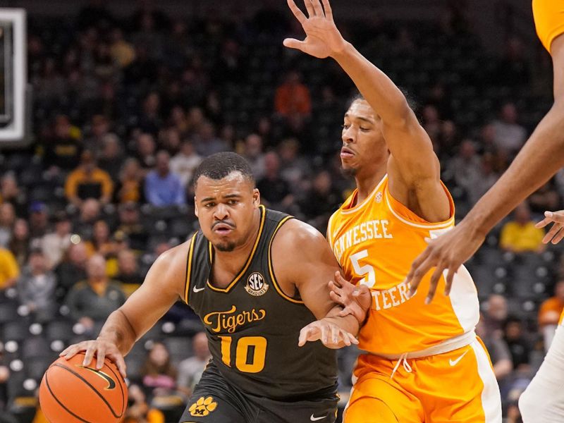 Feb 20, 2024; Columbia, Missouri, USA; Missouri Tigers guard Nick Honor (10) dribbles the ball as Tennessee Volunteers guard Zakai Zeigler (5) defends during the first half at Mizzou Arena. Mandatory Credit: Denny Medley-USA TODAY Sports