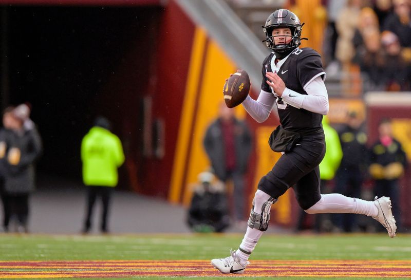 Oct 28, 2023; Minneapolis, Minnesota, USA;  Minnesota Golden Gophers quarter back Athan Kaliakmanis (8) rolls out of the pocket against the Michigan State Spartans during the third quarter at Huntington Bank Stadium. Mandatory Credit: Nick Wosika-USA TODAY Sports