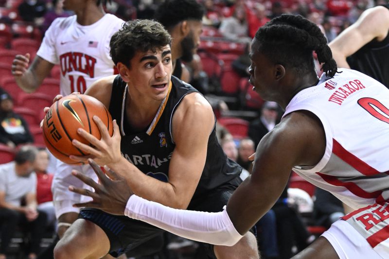 Feb 14, 2023; Las Vegas, Nevada, USA; San Jose State Spartans guard Alvaro Cardenas (13) grabs a rebound near UNLV Runnin' Rebels forward Victor Iwuakor (0) in the first half at Thomas & Mack Center. Mandatory Credit: Candice Ward-USA TODAY Sports